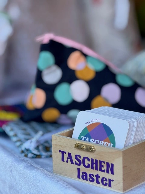 Taschenlaster-Visitenkarten mit farbenfrohen Accessoires im Hintergrund